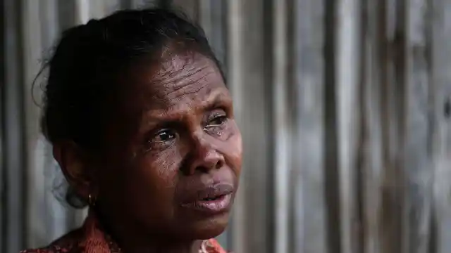 Yohanna Banunaek, cries as she talks about her late daughter Adelina Sau, in Abi village of West Timor, Indonesia.