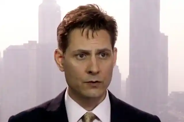 In this file image made from a video taken on 28 March 2018, Michael Kovrig, an adviser with the International Crisis Group, a Brussels-based non-governmental organisation, speaks during an interview in Hong Kong. 