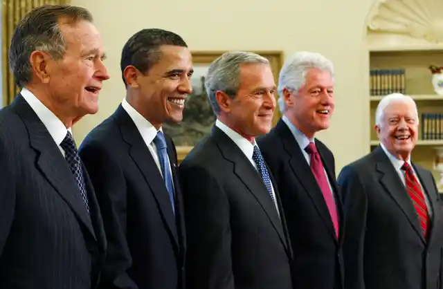 In this 2009 photo, President George W Bush <i>(center)</i> poses with President-elect Barack Obama (second left) and former presidents, George HW Bush (left), Bill Clinton <i>(second right)</i>, and Jimmy Carter <i>(right)</i>, in the Oval Office of the White House in Washington.