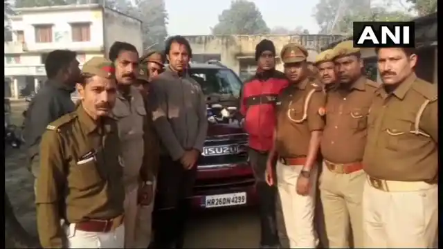 Jyoti Randhawa (center, grey jacket) pictured after his arrest on poaching charges in Uttar Pradesh’s Bahraich district.