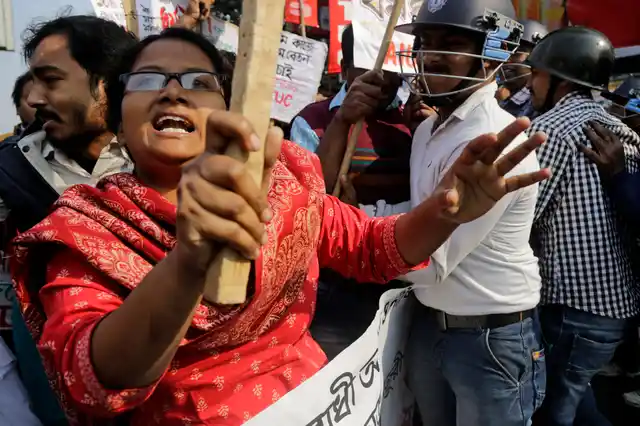 Trade union activists shout slogans as they clash with police on the first day of a two-day general strike called by various trade unions in Kolkata.