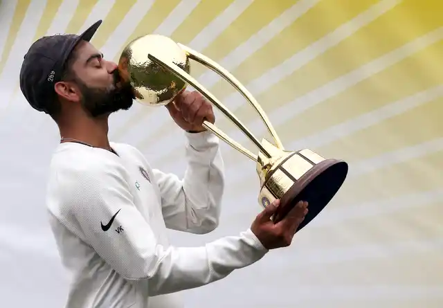 India’s Virat Kohli kisses the Border–Gavaskar Trophy as he celebrate their series win over Australia after play was called off on day 5 of their cricket test match in Sydney, Monday, Jan. 7, 2019. The match is a draw and India wins the series 2-1.