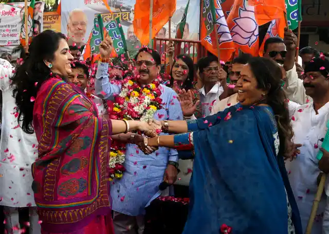 Supporters of Bharatiya Janata Party celebrate India’s Parliament approving a bill providing a 10 percent quota in government jobs for poor upper caste members in Mumbai on Thursday, 10 January 2019. 