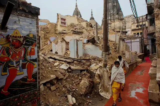 Two young Sanskrit scholars walk along an alley at the demolition site. Quite a few Sanskrit schools have been brought down for the corridor.