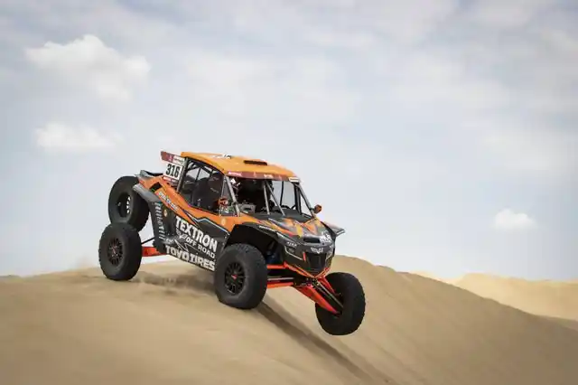 A 4x4 taking on a gigantic dune.
