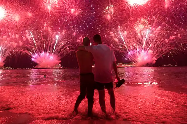Two men watch the fireworks exploding over Copacabana Beach during the New Year’s celebrations in Rio de Janeiro, Brazil, on Tuesday, 1 January 2019. 