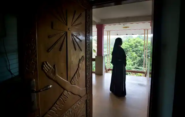 In this Saturday, 3 November, 2018, photo, a Catholic nun stands at the foyer of the St. Francis Mission Home in Kuravilangad.