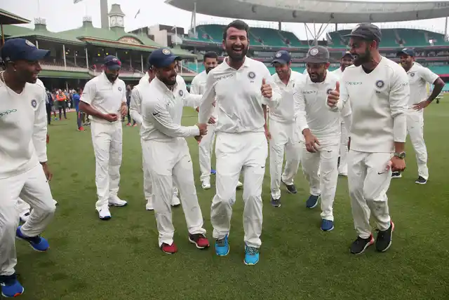 India’s Virat Kohli, right, encourages Cheteshwar Pujara, center, as the team dance as they celebrate their series win over Australia after play was called off on day 5 of their cricket test match in Sydney, Monday, Jan. 7, 2019. The match is a draw and India wins the series 2-1.
