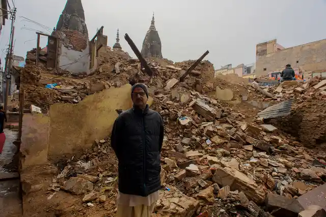 Shravan Kumar Goswami poses for a photograph at the place where his house had once stood.