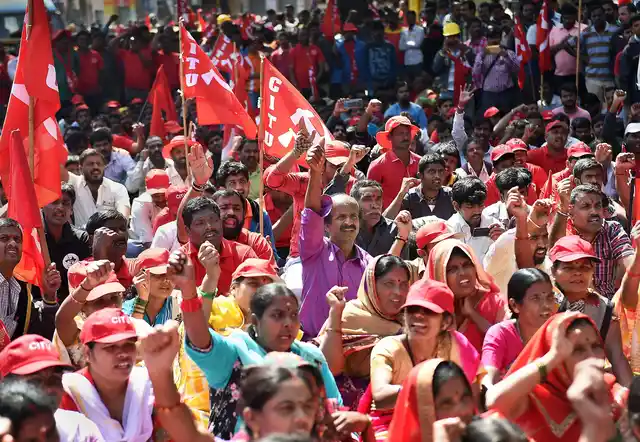 Factory workers and members of Centre of Indian Trade Unions (CITU) shout slogans during the 48-hour long nationwide general strike called by Central trade unions protesting against the “anti-people” policies of the Centre, in Bengaluru on Tuesday, 8 January.