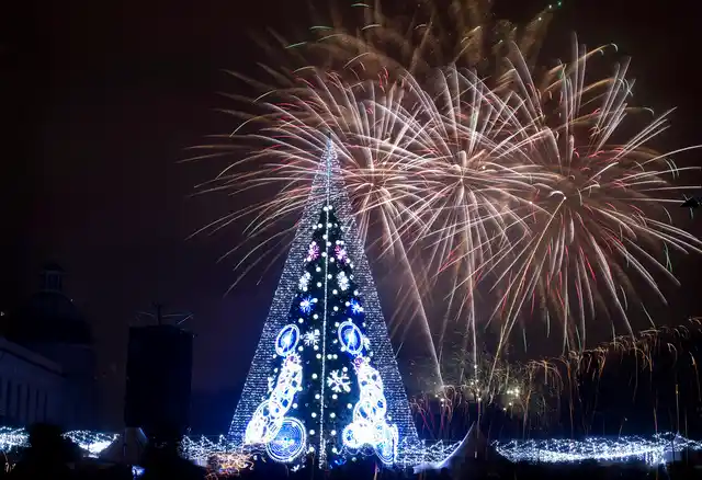 Fireworks light the sky above illuminated Christmas tree at the Cathedral Square in Vilnius, Lithuania, shortly after midnight during the New Year’s celebrations on 1 January 2019. 