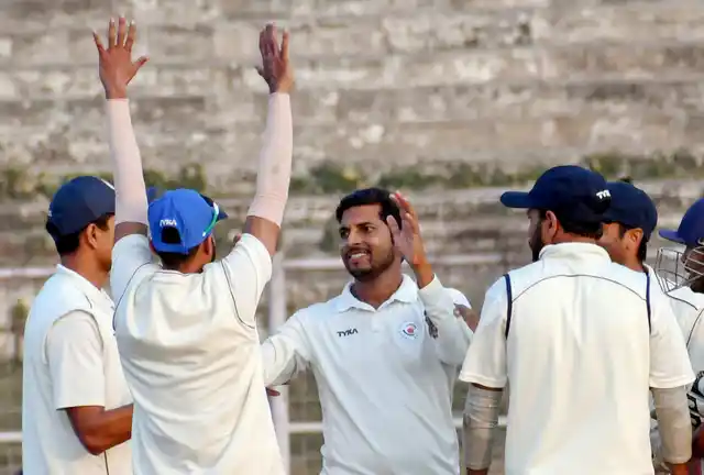 Bihar bowler Ashutosh Aman (C) celebrates with teammates during a Ranji Trophy cricket match.