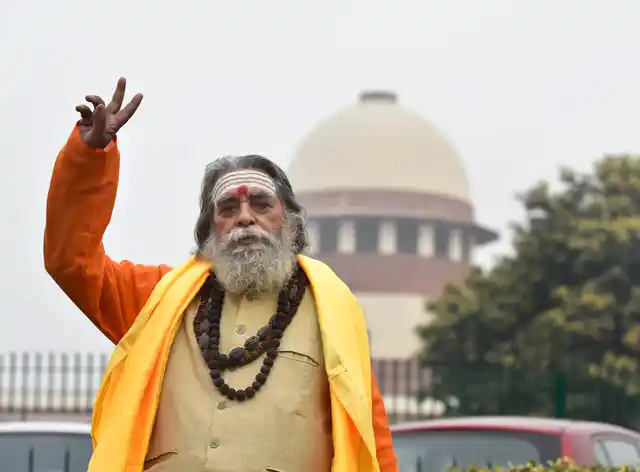 Hindu Mahasabha leader Nand Kishore Mishra flashes a victory sign after a hearing on Ram Janmabhoomi-Babri Masjid land dispute title case in SC, on Friday, 4 January. The next date of the hearing has been fixed as 10 January. 