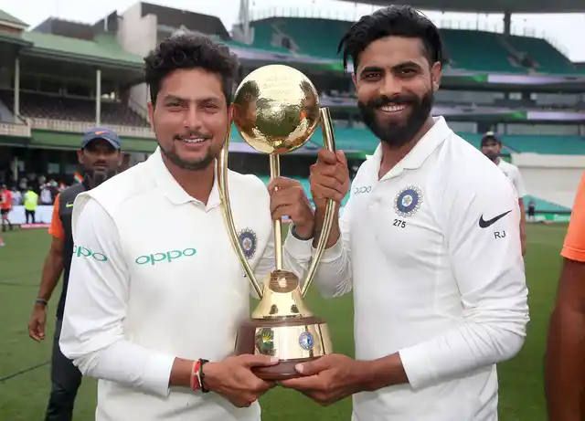 India’s Kuldeep Yadav, left, and Ravindra Jadeja hold the Border-Gavaskar Trophy as they celebrate their series win over Australia after play was called off on day 5 of their cricket test match in Sydney, Monday, Jan. 7, 2019. The match is a draw and India wins the series 2-1.