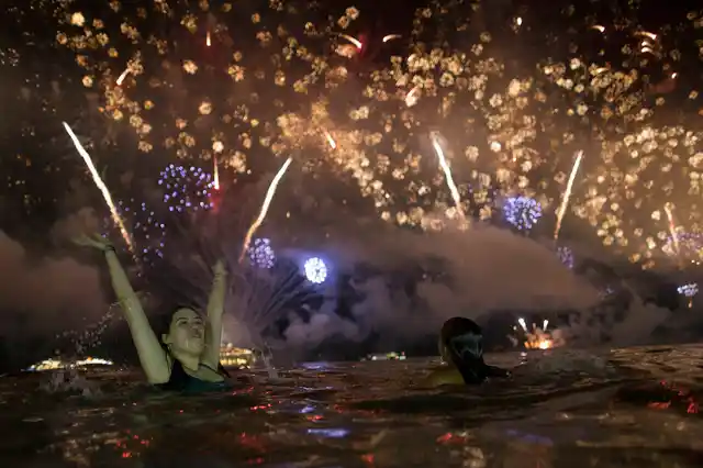 A woman watches the fireworks exploding over Copacabana Beach during the New Year’s celebrations in Rio de Janeiro, Brazil on Tuesday, 1 January 2019. 