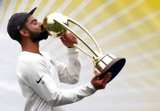 India cricket captain Virat Kohli kisses the trophy as he celebrates India’s series win over Australia after play was called off on day 5 of their cricket test match in Sydney, on Monday, 7 January, 2019.