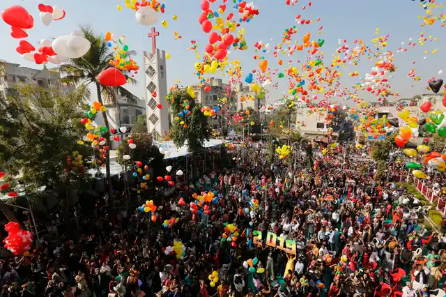 People release balloons as they celebrate the New Year 2019 outside a church in Ahmedabad on Tuesday, 1 January 2019. 
