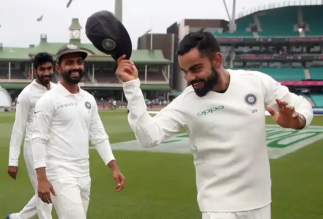 India’s Virat Kohli, right, tips his hat as he celebrate with teammates their series win over Australia after play was called off on day 5 of their cricket test match in Sydney, Monday, Jan. 7, 2019. The match is a draw and India wins the series 2-1.