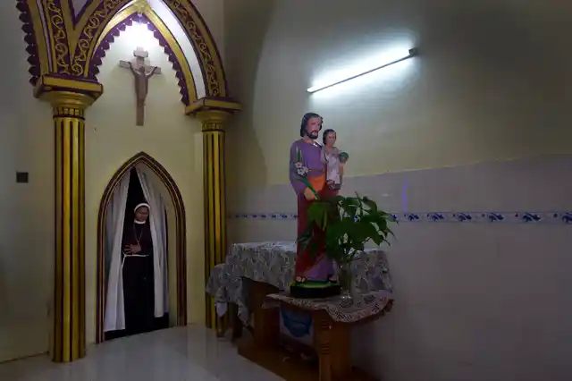 In this Sunday, 4 November, 2018, photo, a Catholic nun walks in the chapel of St. Francis Mission Home in Kuravilangad.
