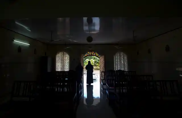 In this Sunday, 4 November, 2018, photo, a nun walks out of chapel of St. Francis Mission Home after offering prayers, in Kuravilangad.