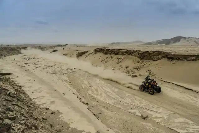 A quadbike races through the deserts.