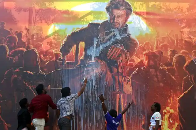 Fans of movie star Rajinikanth celebrate the release of his new film, ‘Petta’, by pouring milk on his poster outside a theatre in Chennai on Thursday, 10 January, 2019.