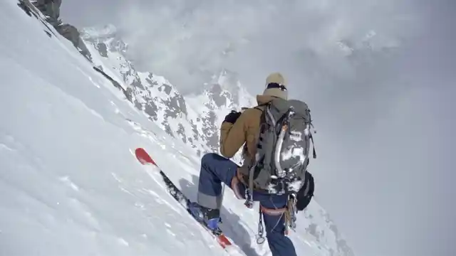 One of the skiers looking down from mountain slope in Switzerland.