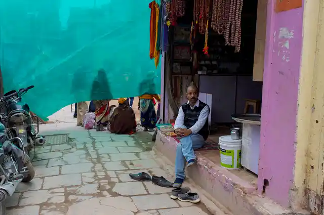 Bhanu Mishra sits at his shop that stands vacant now. He is fighting a legal battle against the authorities.