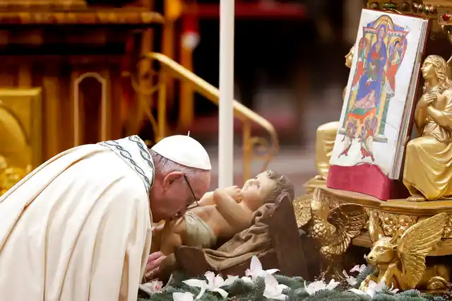 Pope Francis kisses a statue of Baby Jesus as he celebrates a new year’s eve vespers Mass in St. Peter’s Basilica at the Vatican, on Monday, 31 December 2018. 
