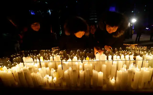 Buddhist light candles during New Year celebrations at Jogyesa Buddhist temple in Seoul, South Korea, on 1 January 2019. 