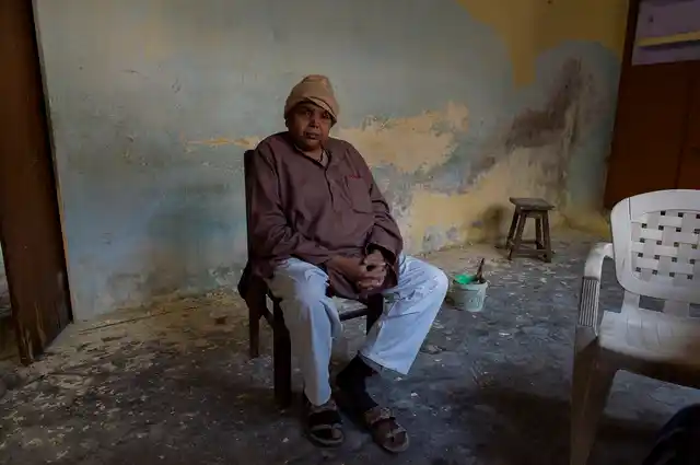 Krishna Kumar Sharma poses for a photograph while supervising renovation work in a house that he bought at Manduadih about five kilometres away from Lahori Tola.