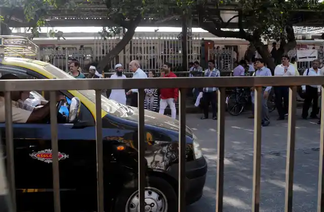 People wait in a queue for taxis on the first day of a two-day long nationwide strike in Mumbai on Tuesday, 8 January.
