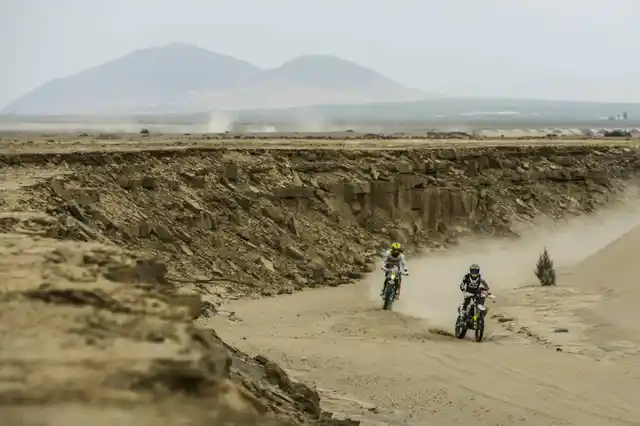 Two bikers from different teams fight it out.