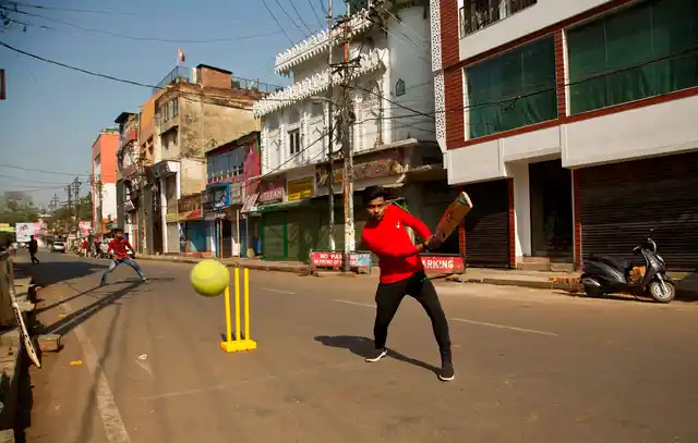 Boys play cricket on a deserted street during an eleven hour general strike called by All Assam Students’ Union (AASU) and North East Students’ Organisation (NESO) in Guwahati on Tuesday, 8 January, 2019.