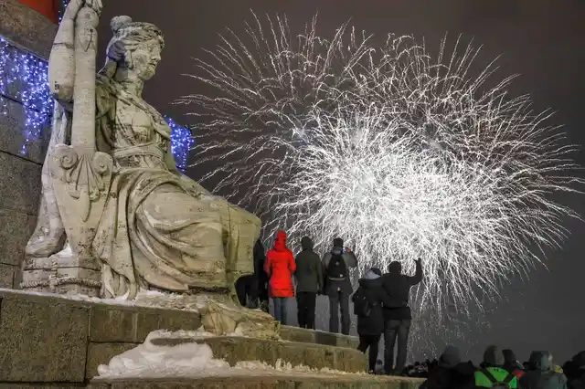 People watch fireworks during New Year celebration in downtown St Petersburg, Russia, on Tuesday, 1 January 2019. 