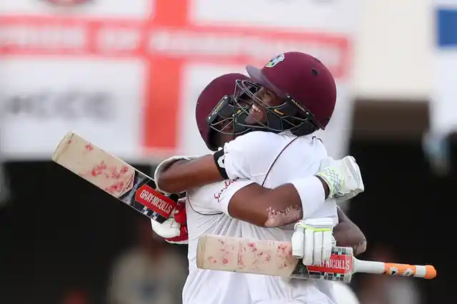 West Indies’ John Campbell and Kraigg Brathwaite celebrate beating England by ten wickets on day three of the second Test cricket match at the Sir Vivian Richards Stadium in North Sound, Antigua and Barbuda, Saturday, Feb. 2, 2019. 