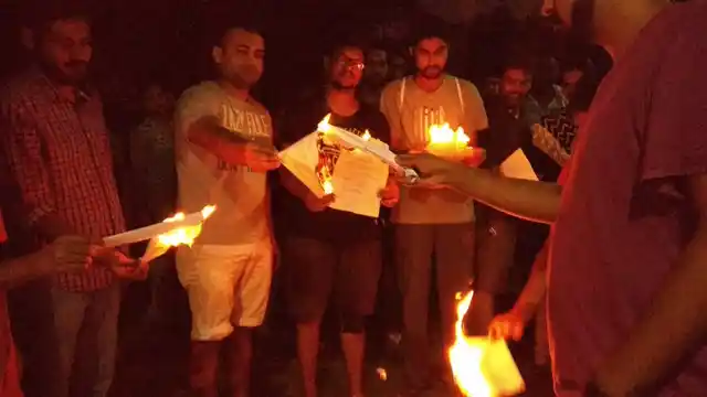 Scholars burn copies of the memo as symbolic rejection.