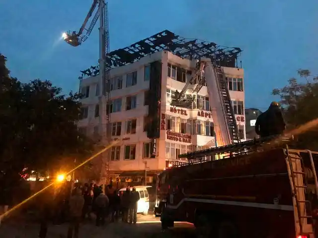 In this photo provided by Sivanand Chand, a hotel guest who was rescued, firefighters rescue people during an early morning fire at the Arpit Palace Hotel in the Karol Bagh area.