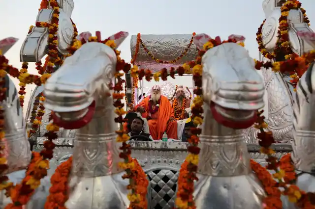 Sadhus participate in a procession towards the Sangam, the confluence of rivers Ganges and Yamuna, during the Kumbh Mela in Prayagraj. 