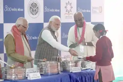 Vrindavan: Prime Minister Narendra Modi, Uttar Pradesh Governor Ram Naik serve food to children during a programme organsied to mark the serving of "3rd billionth meal" by Akshaya Patra Foundation at Vrindavan Chandrodaya Mandir on Feb. 11, 2019. (Photo: IANS)