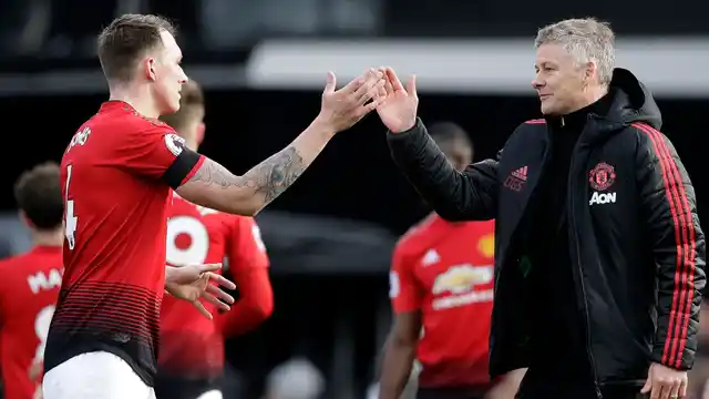 Manchester United coach Ole Gunnar Solskjaer (right) and Manchester United’s Phil Jones celebrate at the end of the English Premier League match against Fulham on Saturday.