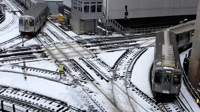 Chicago’s El trains move along snow-covered tracks Monday, 28 January 2019, in Chicago. The plunging temperatures expected later this week that have forecasters especially concerned. 