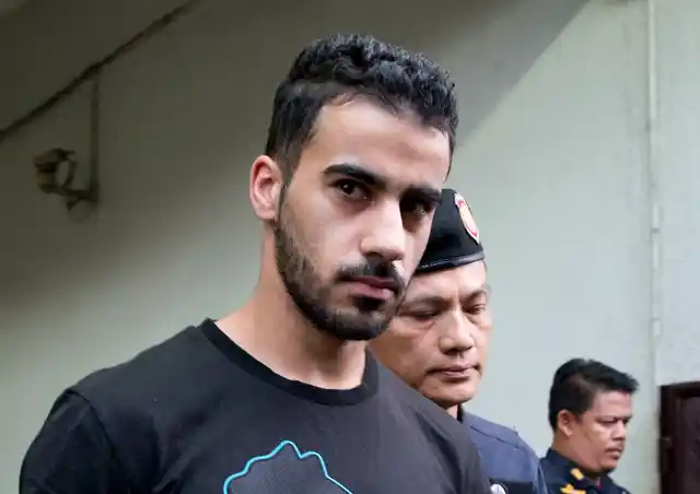 Thai prison guards lead Bahraini football player Hakeem al-Araibi, second left, from a court house in Bangkok, Thailand, Tuesday, Dec. 11, 2018. A Thai court has ruled that the soccer player who holds refugee status in Australia can be held for 60 days pending the completion of an extradition request by Bahrain, the homeland he fled four years ago on account of alleged political persecution.