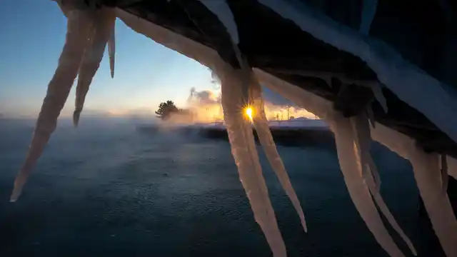 The sun rises behind icicles formed on the harbour in Port Washington, Wisconsin, on Wednesday, 30 January 2019, A deadly arctic deep freeze enveloped the Midwest with record-breaking temperatures. 