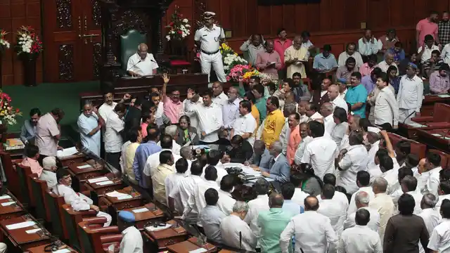 BJP MLAs storm the well of the house. 