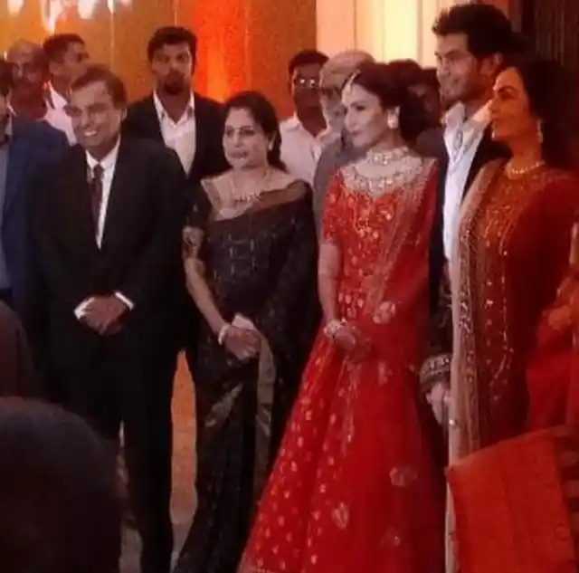 Mukesh Ambani and Nita Amabani with the married couple.