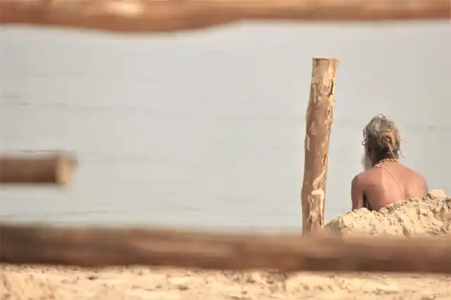 A Sadhu sitting by the banks of a river.