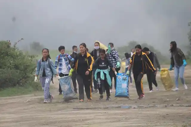 Bags full of waste being carried. 