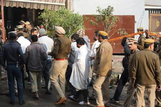 Hotel guests arrive to identify their belongings after an early morning fire killed at least 17 people at the Arpit Palace Hotel in Karol Bagh.
