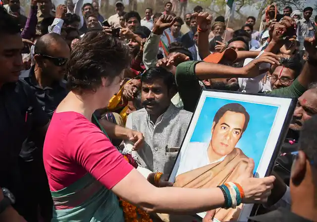 Congress’ eastern Uttar Pradesh in-charge Priyanka Gandhi Vadra holds a portrait of her father, former prime minster Rajiv Gandhi as she starts her party’s campaign for the Lok Sabha elections in UP, from Manaiya Ghat in Kachnar tehsil of Prayagraj. 